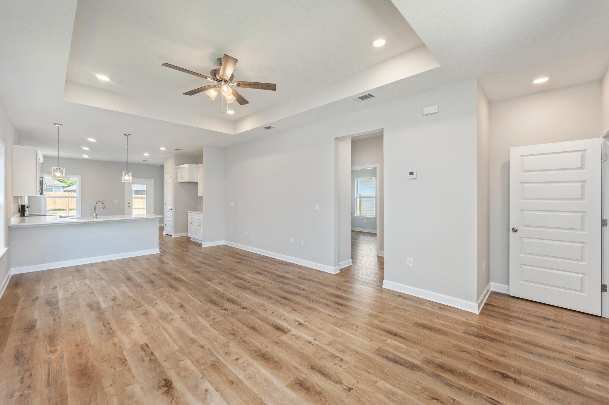 73 Lafayette Creek Freeport, FL 32439 - Photo 8 of 38 a view of an empty room and kitchen with wooden floor