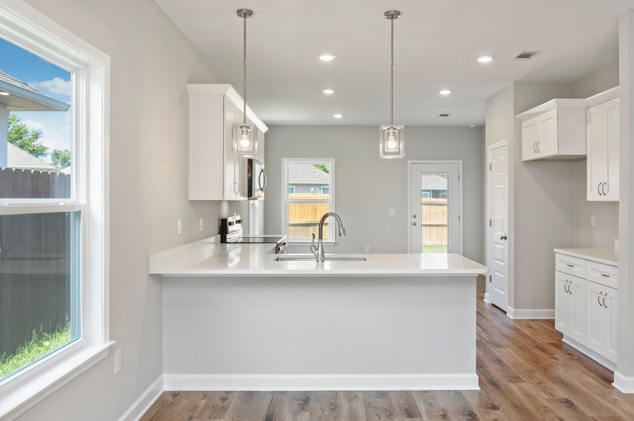 73 Lafayette Creek Freeport, FL 32439 - Photo 9 of 38 a view of a kitchen with kitchen island a sink stainless steel appliances and a window