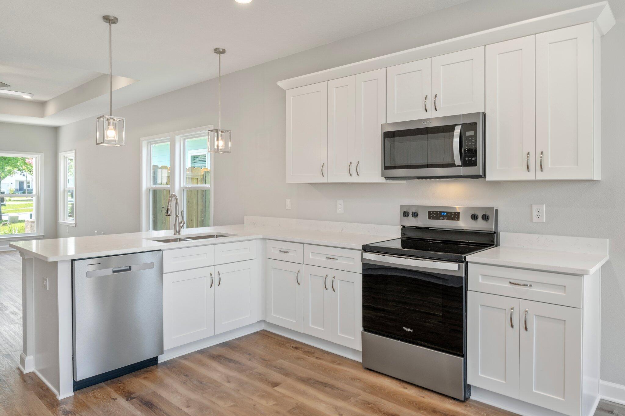 73 Lafayette Creek Freeport, FL 32439 - Photo 10 of 38 a kitchen with white cabinets stainless steel appliances and sink