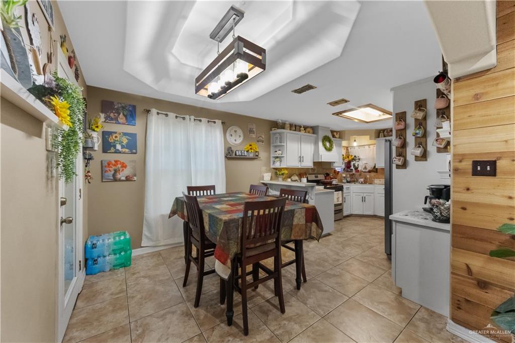 15501 East Davis Road Edinburg, TX 78542 - Photo 7 of 20 Dining area with tray ceiling and contemporary linear chandelier