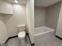 a bathroom with a toilet and a bathtub