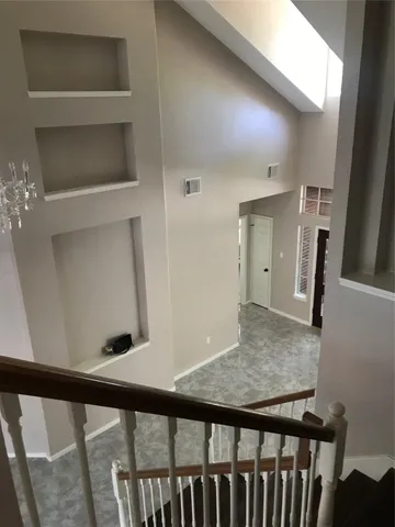 a view of a hallway and wooden floor