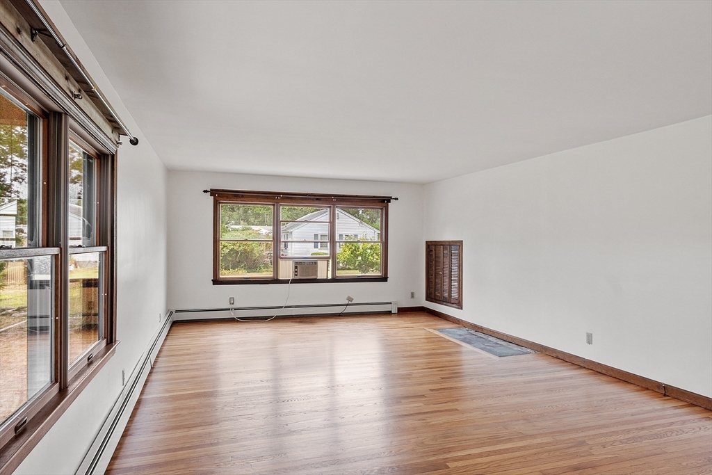 4 22nd Street Wareham, MA 02558 - Photo 11 of 22 a view of an empty room with wooden floor and a window