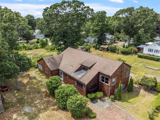 an aerial view of a house with garden space and street view