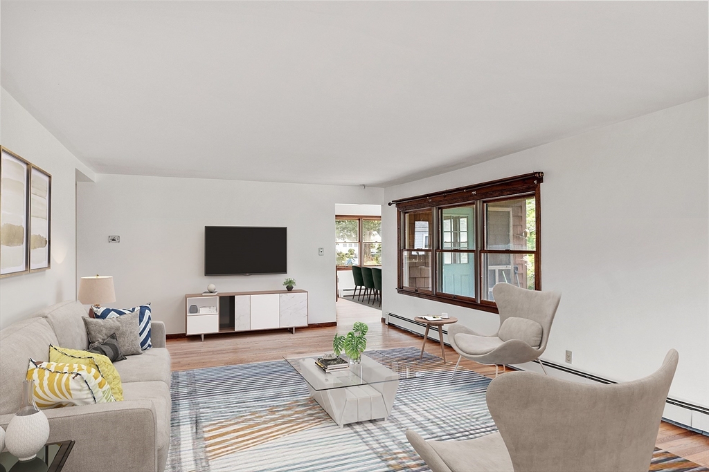 4 22nd Street Wareham, MA 02558 - Photo 3 of 22 a living room with furniture a flat screen tv and a large window