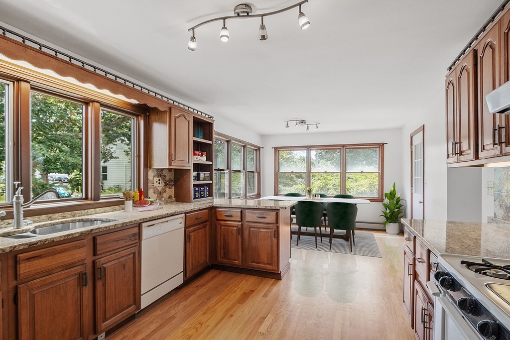 4 22nd Street Wareham, MA 02558 - Photo 5 of 22 a kitchen with a table chairs stove and cabinets