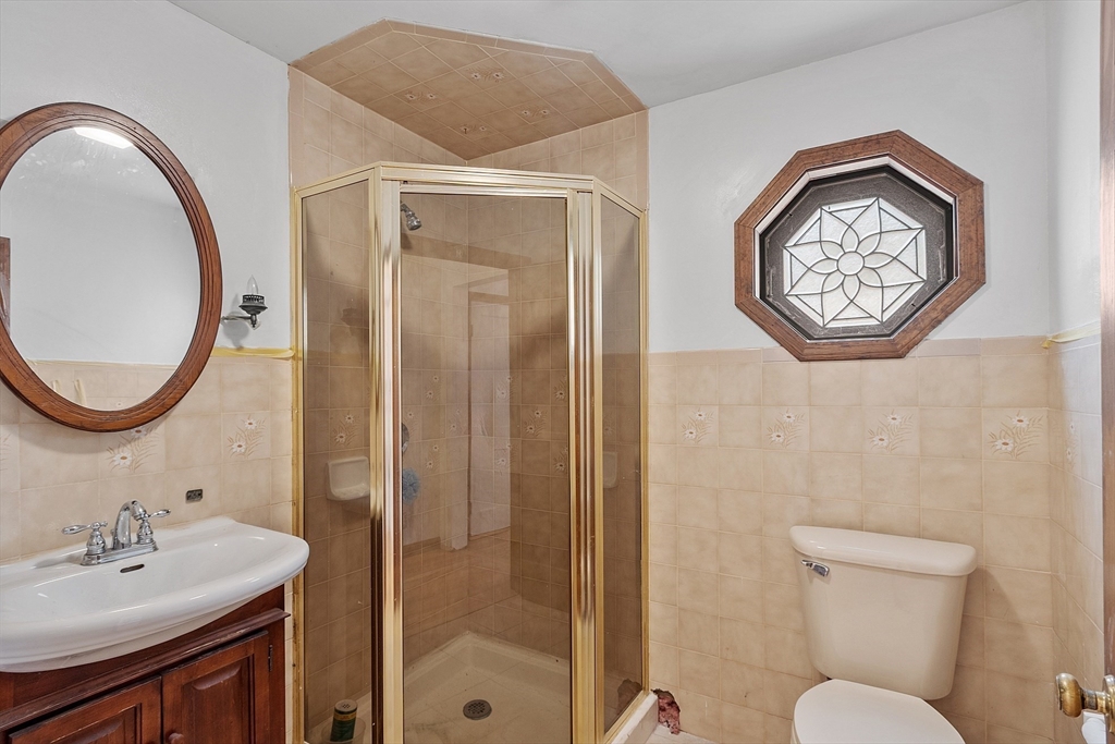 4 22nd Street Wareham, MA 02558 - Photo 10 of 22 a bathroom with a toilet a sink and a mirror