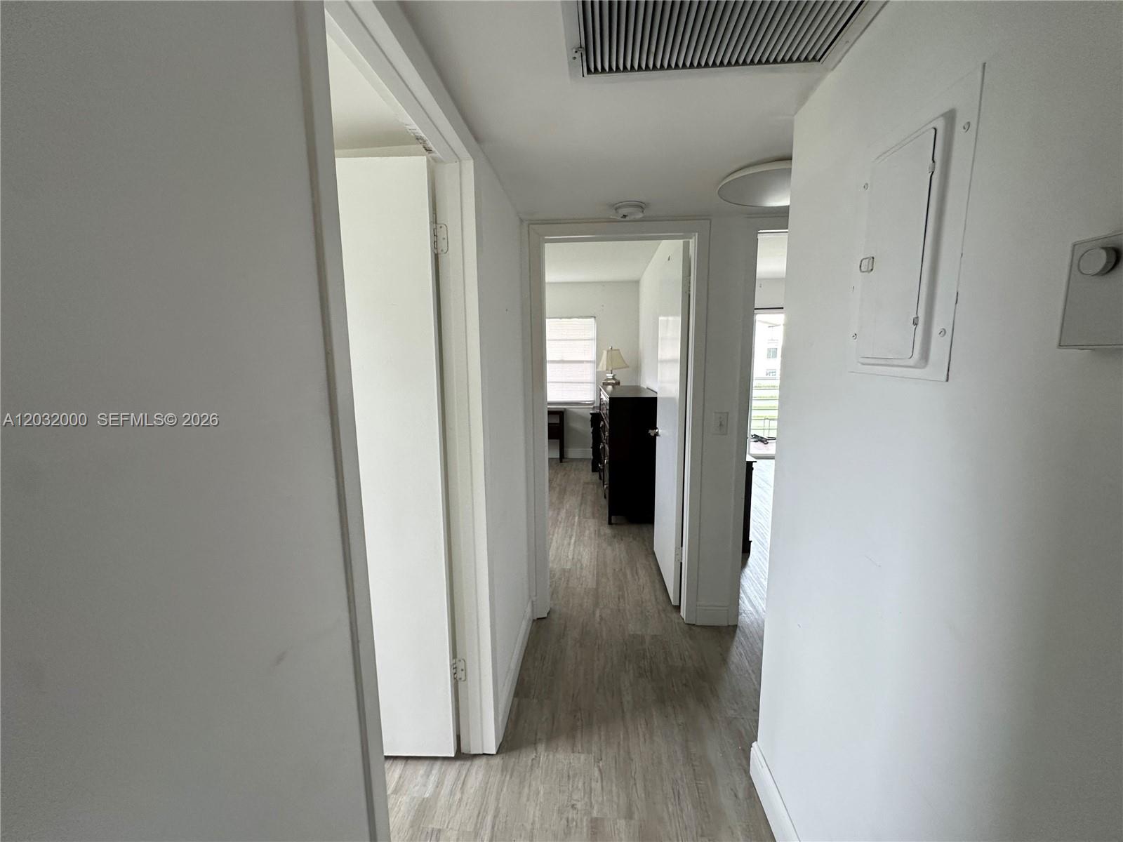 445 Mansfield K, Unit 445 Boca Raton, FL 33434 - Photo 7 of 12 a view of a hallway with wooden floor