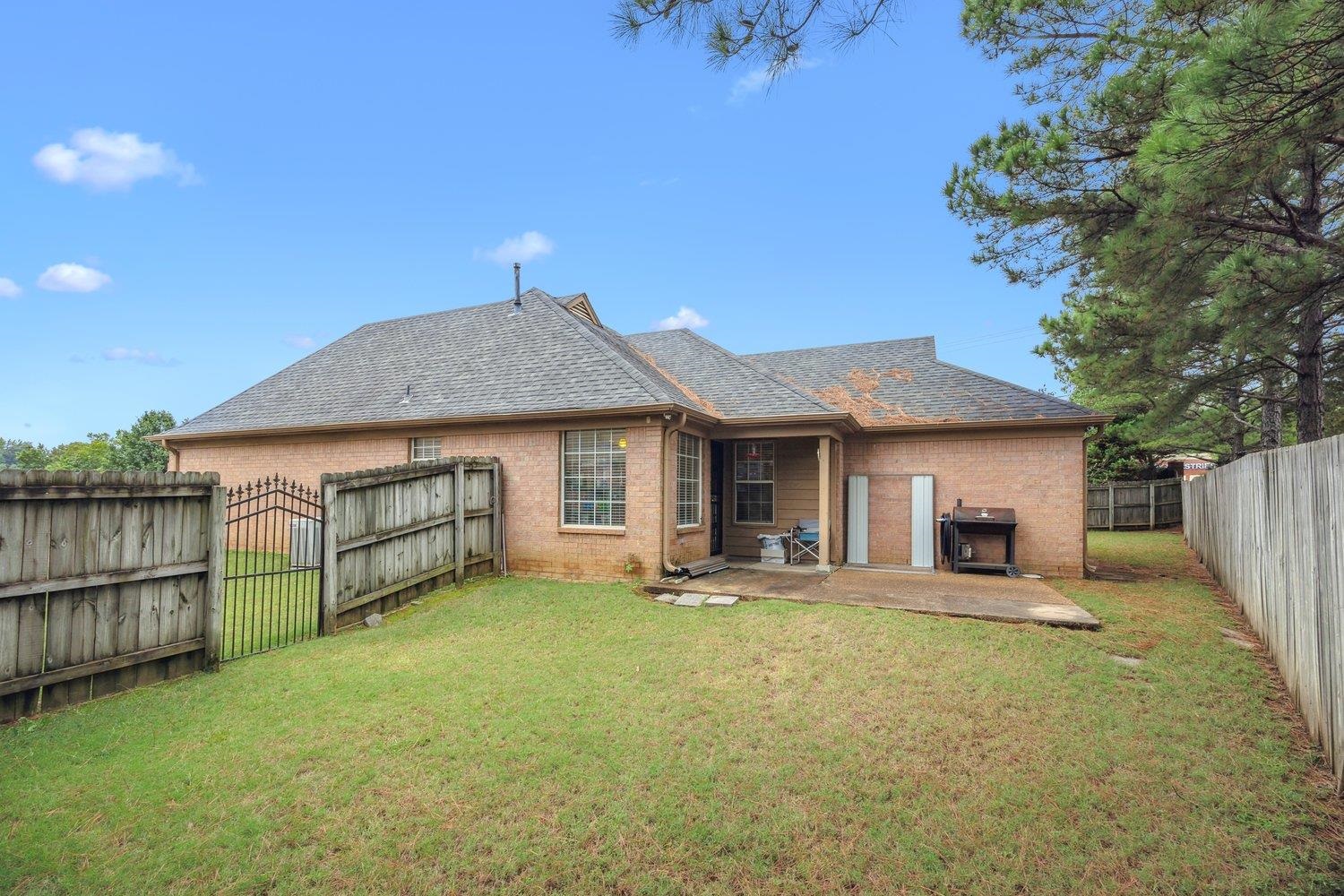 10076 Cross Ridge Road Cordova, TN 38018 - Photo 20 of 21 Rear view of house featuring a yard and a patio area