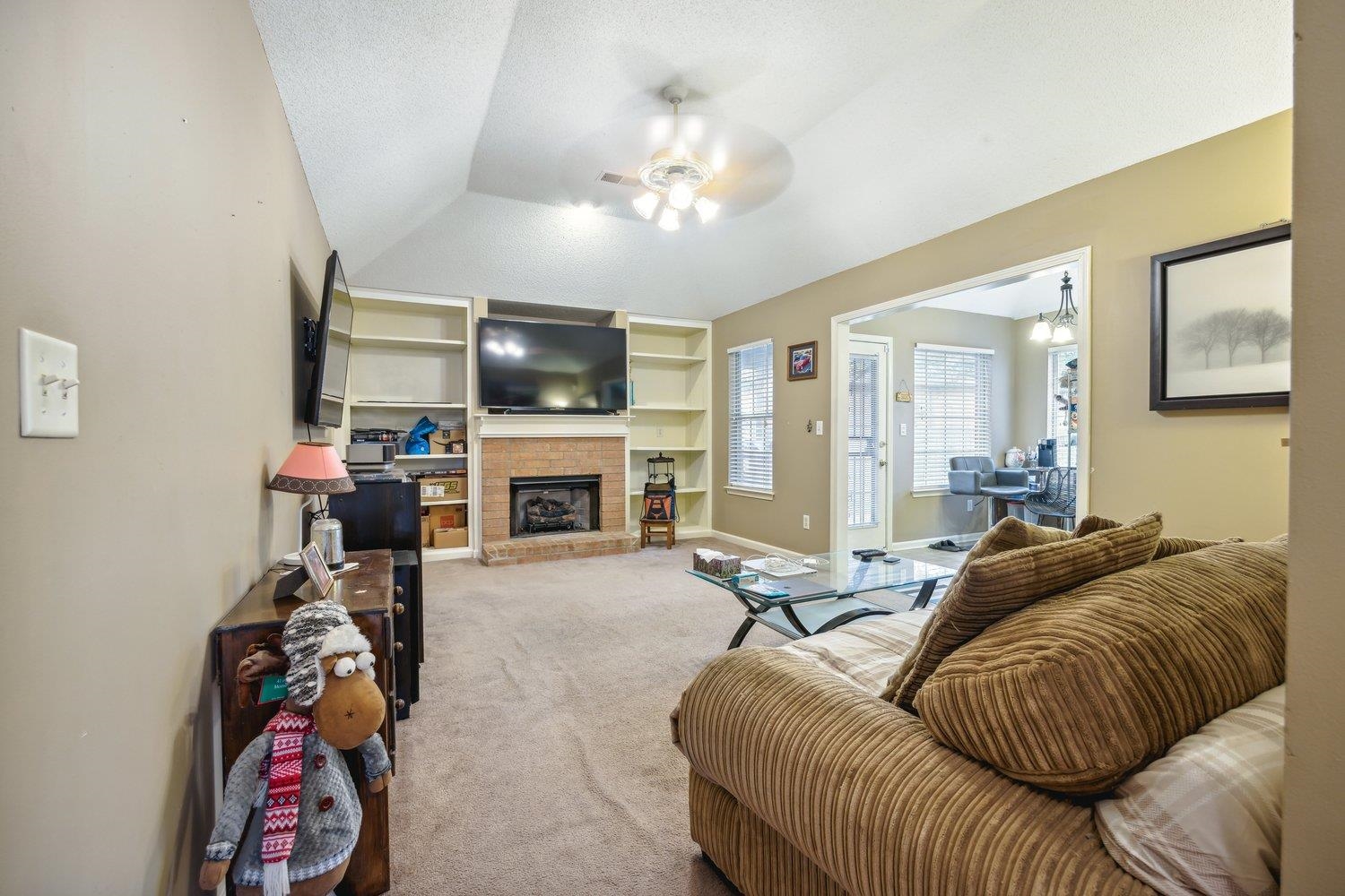 10076 Cross Ridge Road Cordova, TN 38018 - Photo 7 of 21 Carpeted living room with ceiling fan, a fireplace, and lofted ceiling