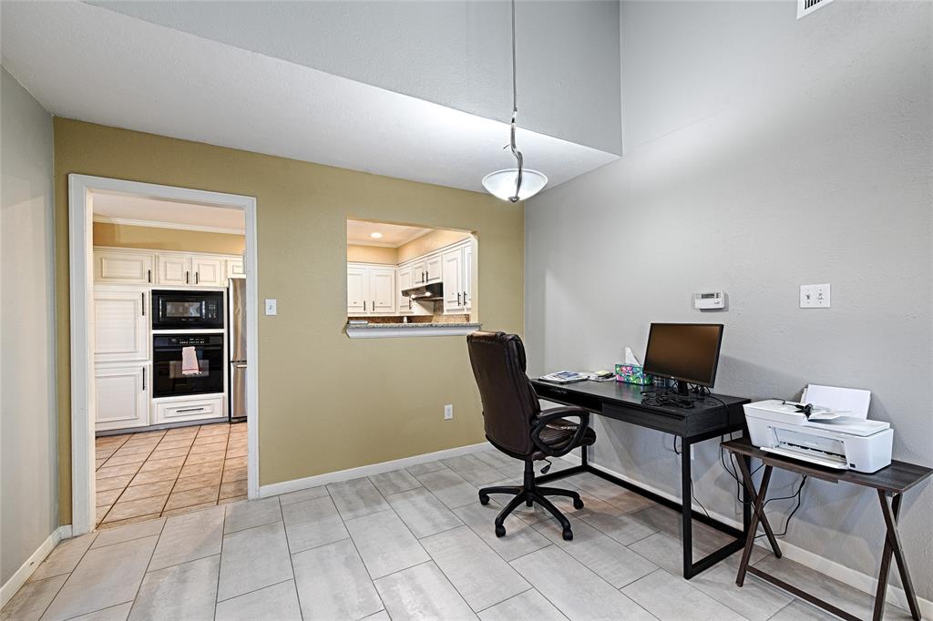 15632 Moondust Drive Dallas, TX 75248 - Photo 13 of 36 a view of a workspace with furniture and a window