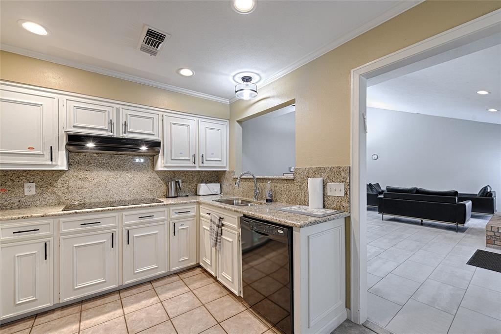 15632 Moondust Drive Dallas, TX 75248 - Photo 17 of 36 Kitchen with light tile patterned floors, black appliances, recessed lighting, white cabinetry, and light stone counters