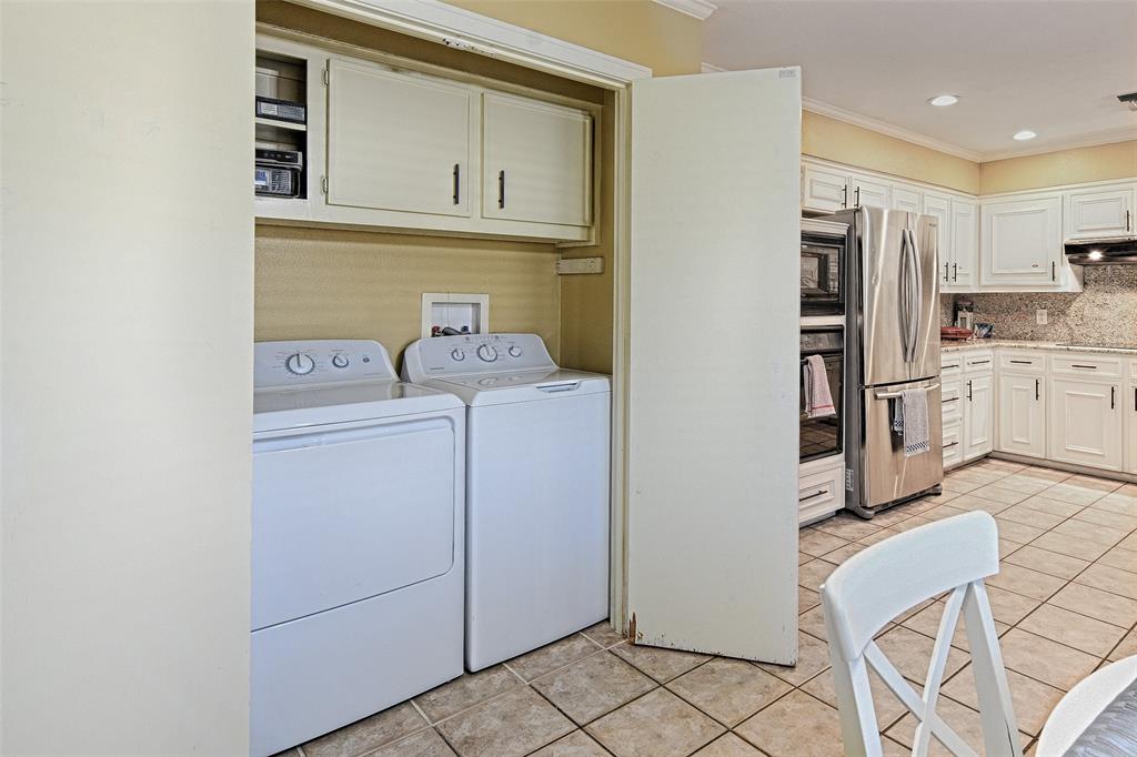 15632 Moondust Drive Dallas, TX 75248 - Photo 21 of 36 a view of kitchen and washer and dryer