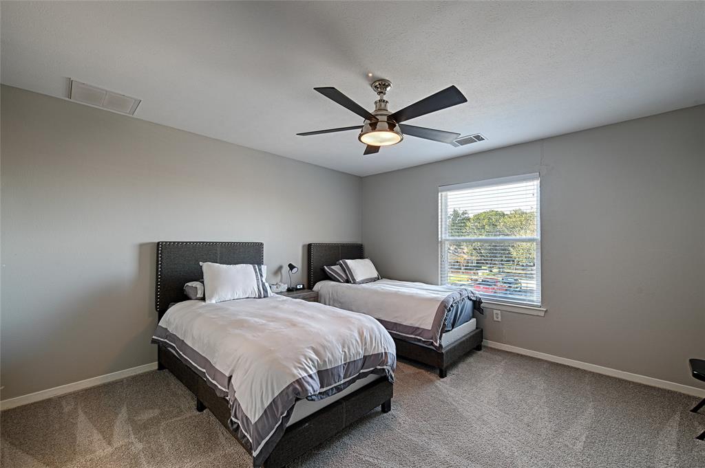 15632 Moondust Drive Dallas, TX 75248 - Photo 22 of 36 Bedroom with light carpet, a ceiling fan, and a textured ceiling