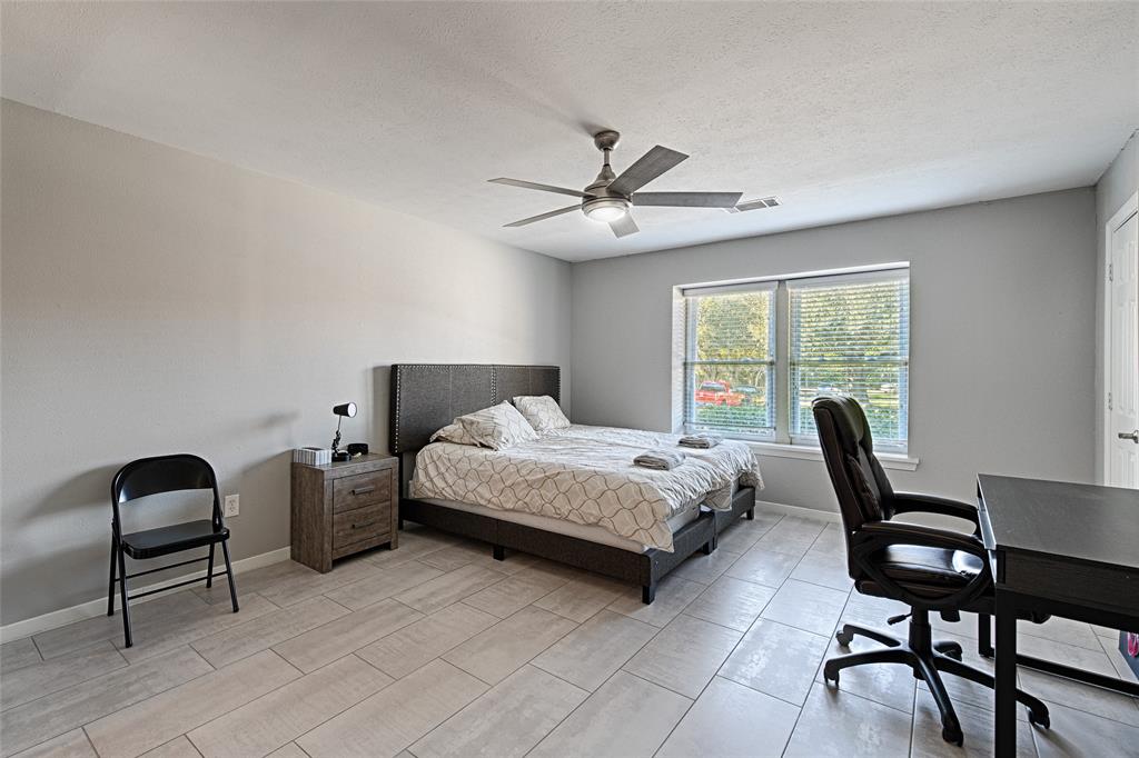 15632 Moondust Drive Dallas, TX 75248 - Photo 23 of 36 a bedroom with a bed chair and a window