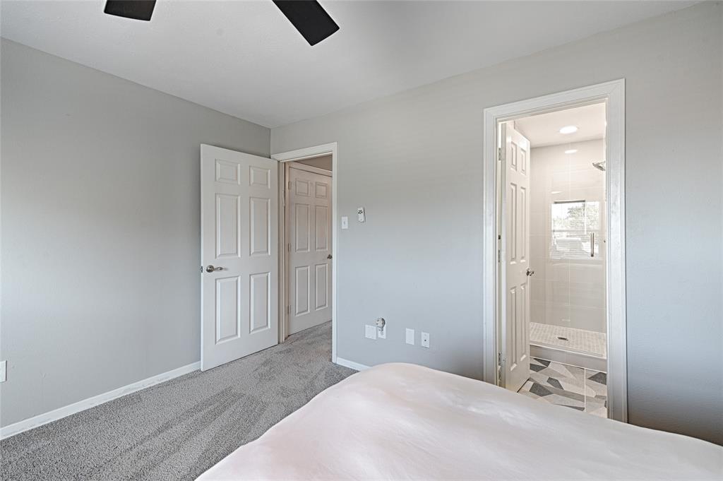 15632 Moondust Drive Dallas, TX 75248 - Photo 27 of 36 a bedroom with a bed and a shower