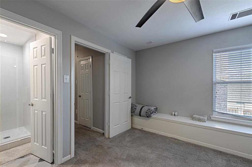 15632 Moondust Drive Dallas, TX 75248 - Photo 30 of 36 Bathroom with light colored carpet, a shower stall, and ceiling fan