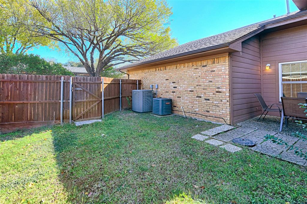 15632 Moondust Drive Dallas, TX 75248 - Photo 34 of 36 a view of a backyard with wooden fence and a large tree