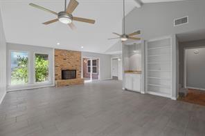 15632 Moondust Drive Dallas, TX 75248 - Photo 6 of 36 Unfurnished living room featuring a brick fireplace and baseboards