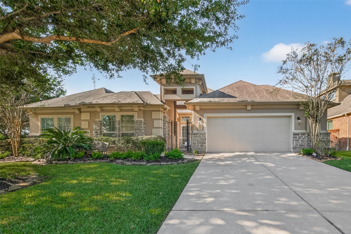 21331 Winding Path Way Richmond, TX 77406 - Photo 1 of 42 a front view of a house with a garden and yard