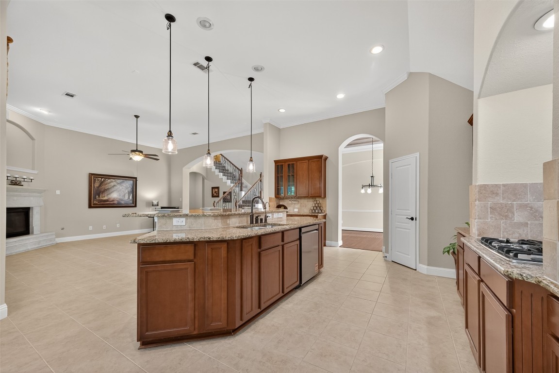 21331 Winding Path Way Richmond, TX 77406 - Photo 15 of 42 a kitchen with stainless steel appliances kitchen island granite countertop a sink and a stove