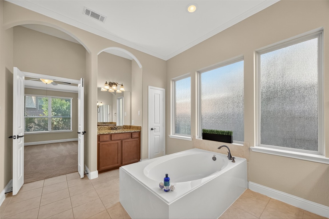 21331 Winding Path Way Richmond, TX 77406 - Photo 21 of 42 a bathroom with a tub a sink and a large mirror