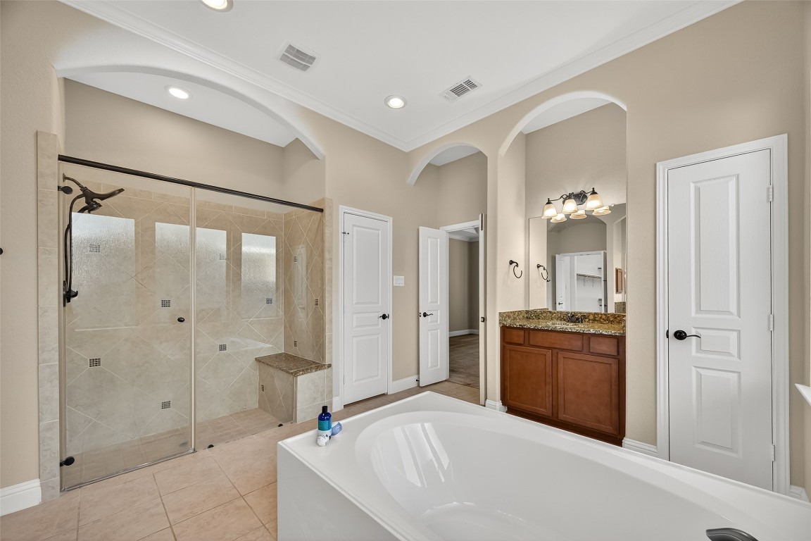 21331 Winding Path Way Richmond, TX 77406 - Photo 22 of 42 a spacious bathroom with a granite countertop sink mirror and shower