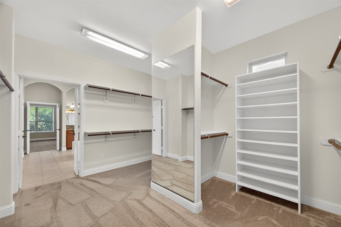 21331 Winding Path Way Richmond, TX 77406 - Photo 24 of 42 a view of walk in closet with empty racks