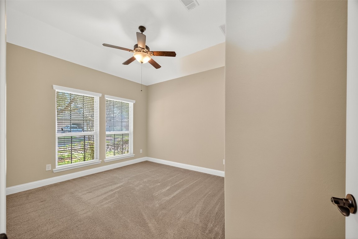 21331 Winding Path Way Richmond, TX 77406 - Photo 30 of 42 an empty room with windows and fan