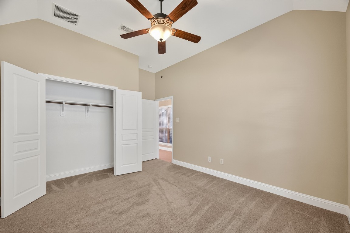 21331 Winding Path Way Richmond, TX 77406 - Photo 31 of 42 an empty room with closet and a ceiling fan