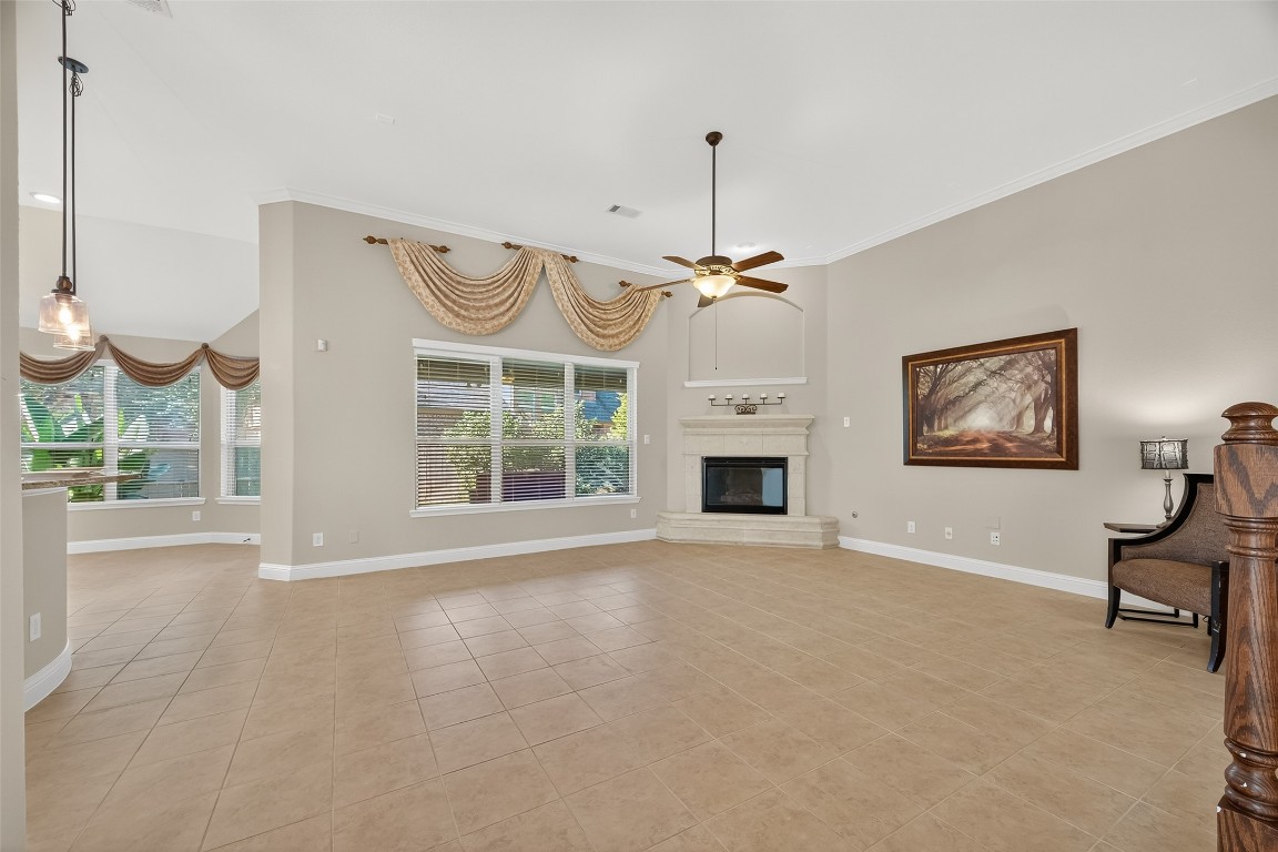 21331 Winding Path Way Richmond, TX 77406 - Photo 9 of 42 a view of an empty room with a fireplace and a window