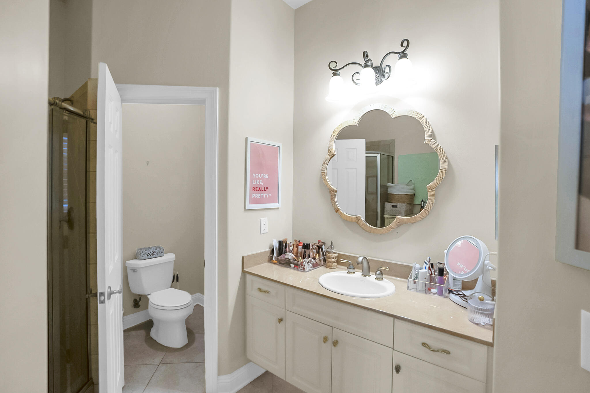 4372 Stonebridge Road Destin, FL 32541 - Photo 45 of 83 a bathroom with a toilet sink and mirror