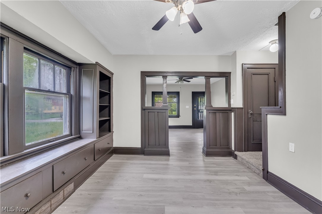 1144 East 145th Street, Unit 1/RIGHT Cleveland, OH 44110 - Photo 8 of 20 Spacious room featuring wood-finish flooring, a ceiling fan, and light gray wall paint