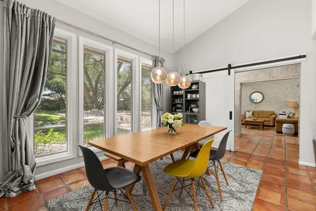 a view of a dining room with furniture wooden floor and a chandelier