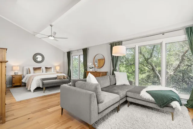 a bedroom with a bed and a refrigerator