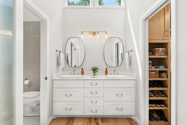 a view of walk in closet with clothes and shoes