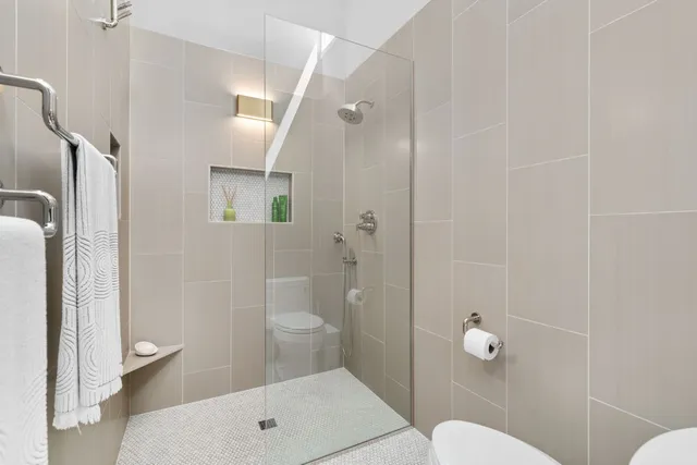 a bedroom with a bed a large window and chair