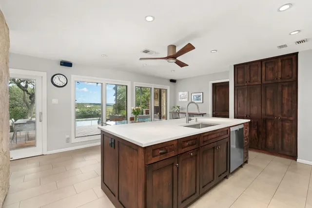 a kitchen with stainless steel appliances granite countertop a sink stove and cabinets