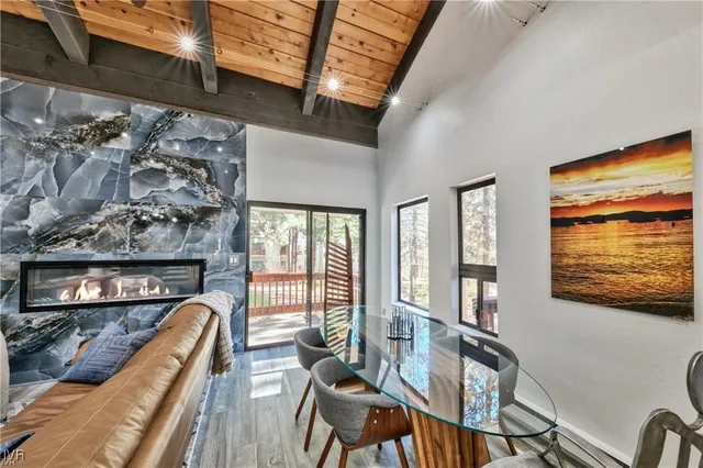 a living room with furniture a flat screen tv and a floor to ceiling window