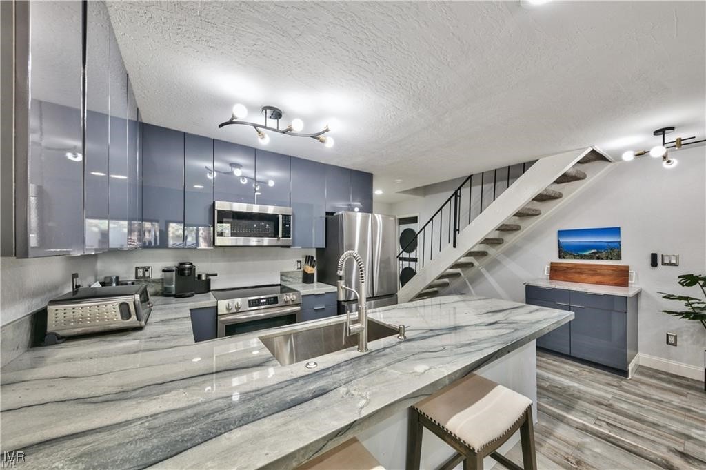 807 Alder Avenue, Unit 38 Incline Village, NV 89451 - Photo 4 of 15 a kitchen with stainless steel appliances granite countertop a sink stove and refrigerator
