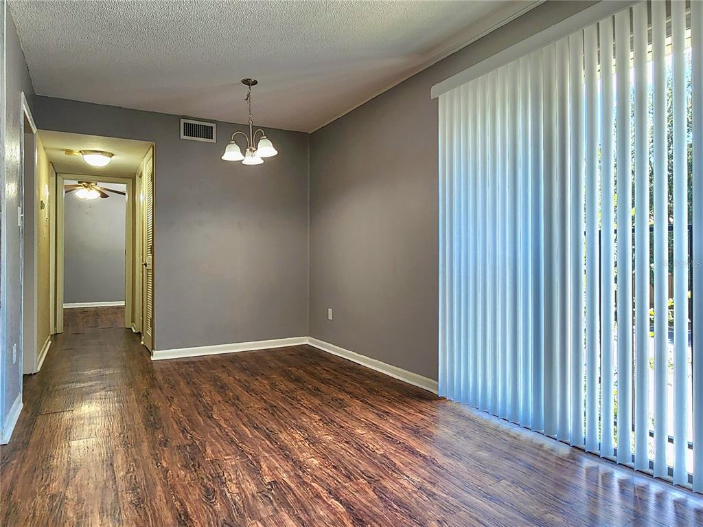 507 Northwest 39th Road, Unit 237 Gainesville, FL 32607 - Photo 3 of 21 wooden floor in an empty room with a window