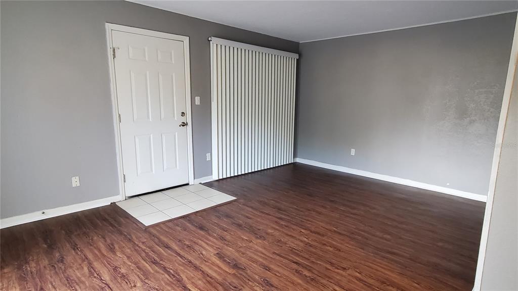 507 Northwest 39th Road, Unit 237 Gainesville, FL 32607 - Photo 4 of 21 a view of an empty room with wooden floor