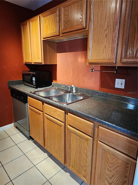 507 Northwest 39th Road, Unit 237 Gainesville, FL 32607 - Photo 8 of 21 a kitchen with granite countertop cabinets stainless steel appliances and a sink
