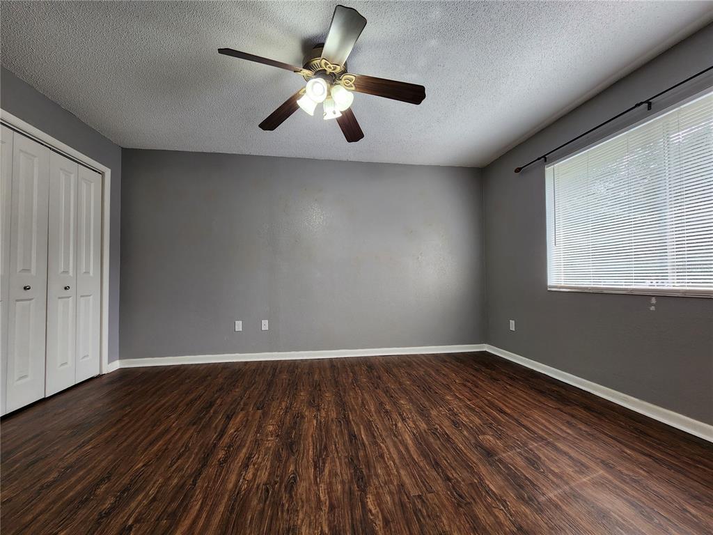 507 Northwest 39th Road, Unit 237 Gainesville, FL 32607 - Photo 10 of 21 wooden floor in an empty room with a window