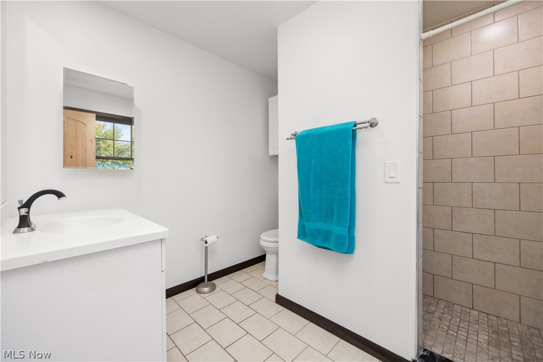 6760 Mason Road Berlin Heights, OH 44814 - Photo 18 of 49 Full bathroom with vanity, a shower stall, and light tile patterned flooring