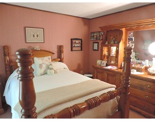 144 Whitins Road Sutton, MA 01590 - Photo 12 of 19 a bedroom with a bed and a mirror