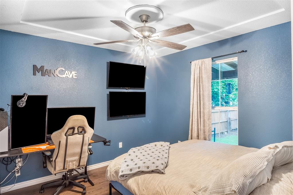 161 Columbia Street Cleburne, TX 76031 - Photo 13 of 19 a bedroom with a bed and a chandelier