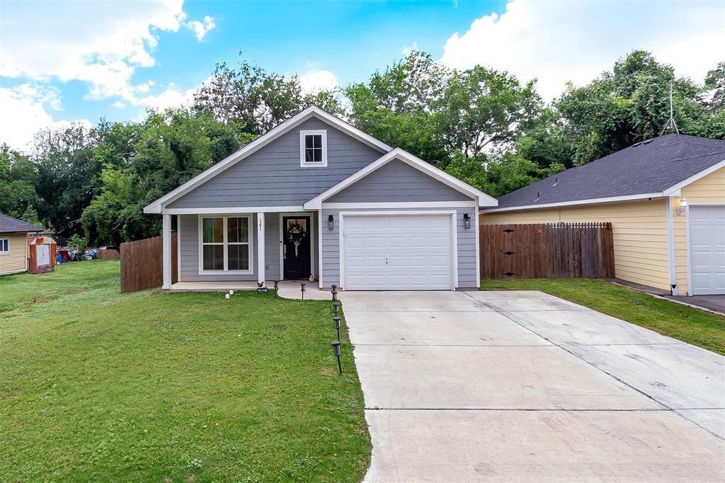 161 Columbia Street Cleburne, TX 76031 - Photo 2 of 19 a front view of a house with a garden