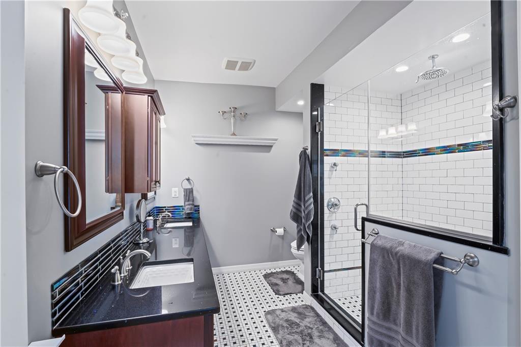 4119 Butler Street Pittsburgh, PA 15201 - Photo 16 of 23 a bathroom with a sink and a mirror