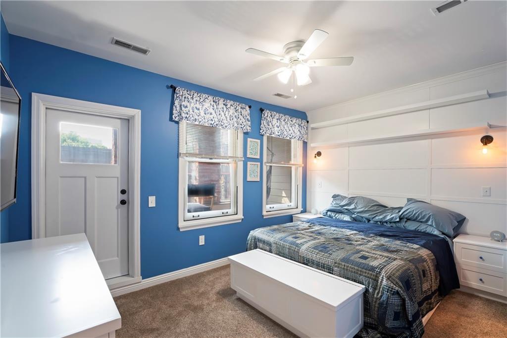 4119 Butler Street Pittsburgh, PA 15201 - Photo 18 of 23 a bedroom with a bed and a chandelier